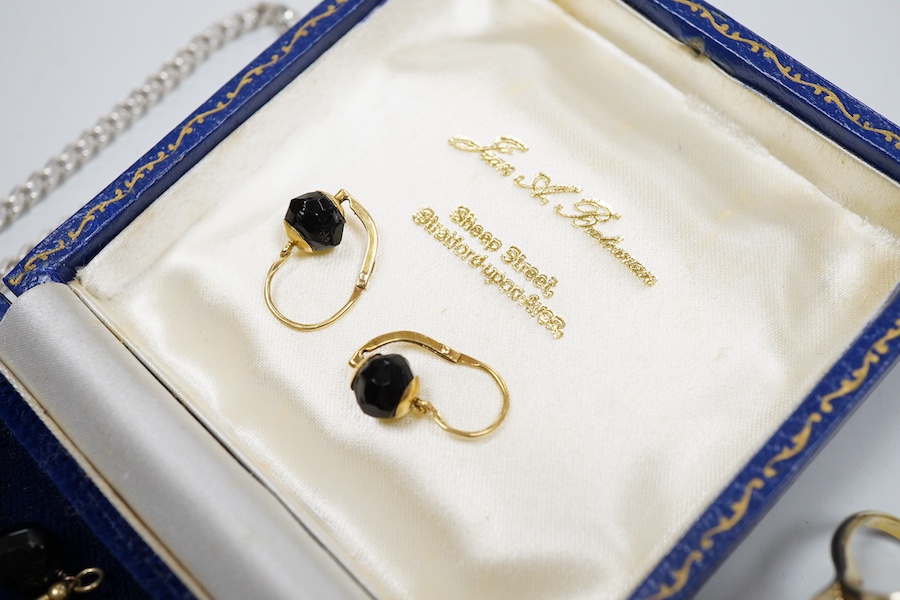 A collection of jewels, comprising: two amber pendants and an amber ring, each mounted in silver; a pair of gilt metal and enamel earrings of floral design; a pair of gilt metal earrings; a silver and cultured brooch; a